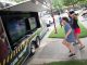 Children play video games outside of a video game truck.