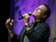 Jon Secada sings into a microphone.