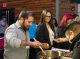 People plating their food at the buffet