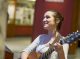 A woman playing guitar