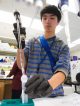 A student fills a test tube during a hands-on demonstration.