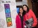 Two girls pose in front of the Science Scholars sign