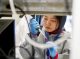 A girl puts fluids into a test tube.