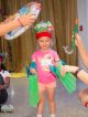 A little girl puts on swimming accessories for an event.