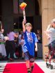 Siblings receive their medals as they walk the red carpet.