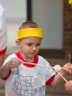 A yellow team member takes a marshmallow with chopsticks.