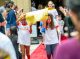 The yellow team carries their sign down the red carpet.