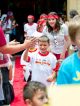 The red team high fives onlookers on the red carpet.