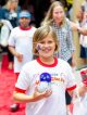 A red team member walks the red carpet.