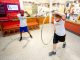 The red team participates in the hula hoop event.
