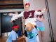 A woman gets wrapped in toilet paper by three children.