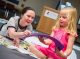 Amelia Grant puts the finishing touches on her pennant with the help of Child Life specialist Brittany O’Shea.