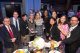 A group of people pose around a table.
