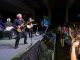 Mike Mills plays with his band while the audience watches.
