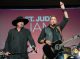 Montgomery Gentry sing and play guitar on stage.