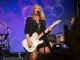 Clare Dunn sings and plays guitar on stage.