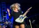 Clare Dunn tosses her hair around while singing.