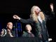 Kim Carnes and her band play on stage.