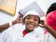 St. Jude patient Keeton smiles in his cap and gown.