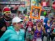 Woman running down Beale Street holding up a sign with a patient