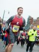 Man running down Beale Street in the St. Jude half-marathon.
