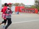 Runners passing the I love Memphis mural on Cooper.