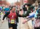 A runner high fiving spectators.