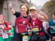 Two half-marathon runners giving their thumbs up.