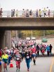 Runners pictured on and under a bridge.