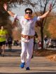 An Elvis impersonator waves at the crowd as he runs the marathon.