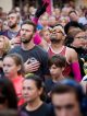 Runners listen to the American anthem before the race begins.