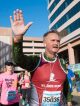 A marathon runner waves as he runs through the St. Jude campus.