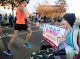 A St. Jude patient cheers and offers high-fives to runners on campus.