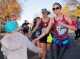 A St. Jude patient high-fives a runner in front of the Target House.