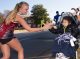 A runner high-fives a child as she passes.