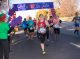 Runners pass the FedEx St. Jude banner in front of Overton Park.