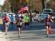 A marathon runner waves an American flag as he makes his way down Peabody Street.