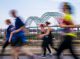 Participants race past the Mississippi River bridge.