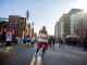 The first marathon finisher wraps himself in a blanket.