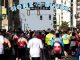 Participants run under the Beale Street "Home of the Blues" sign.