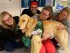 Staff members visit with Puggle outside the hospital.