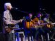 Robby Krieger performs with Rodney Clawson, Kristian Bush, and another man.
