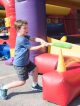 Boy hitting a baseball into an inflatable