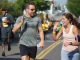 A runner giving an onlooker a high five.