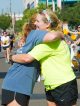Two runners hugging each other.