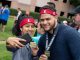Two participants take a selfie while holding up their medals.
