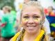 A woman with St. Jude face paint smiles for the camera.