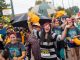 People smile, cheer, and run the course.