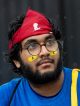 A portrait of a man in a St. Jude bandanna with St. Jude face paint.