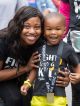 Woman and child smile while wearing a St. Jude Walk/Run medal.